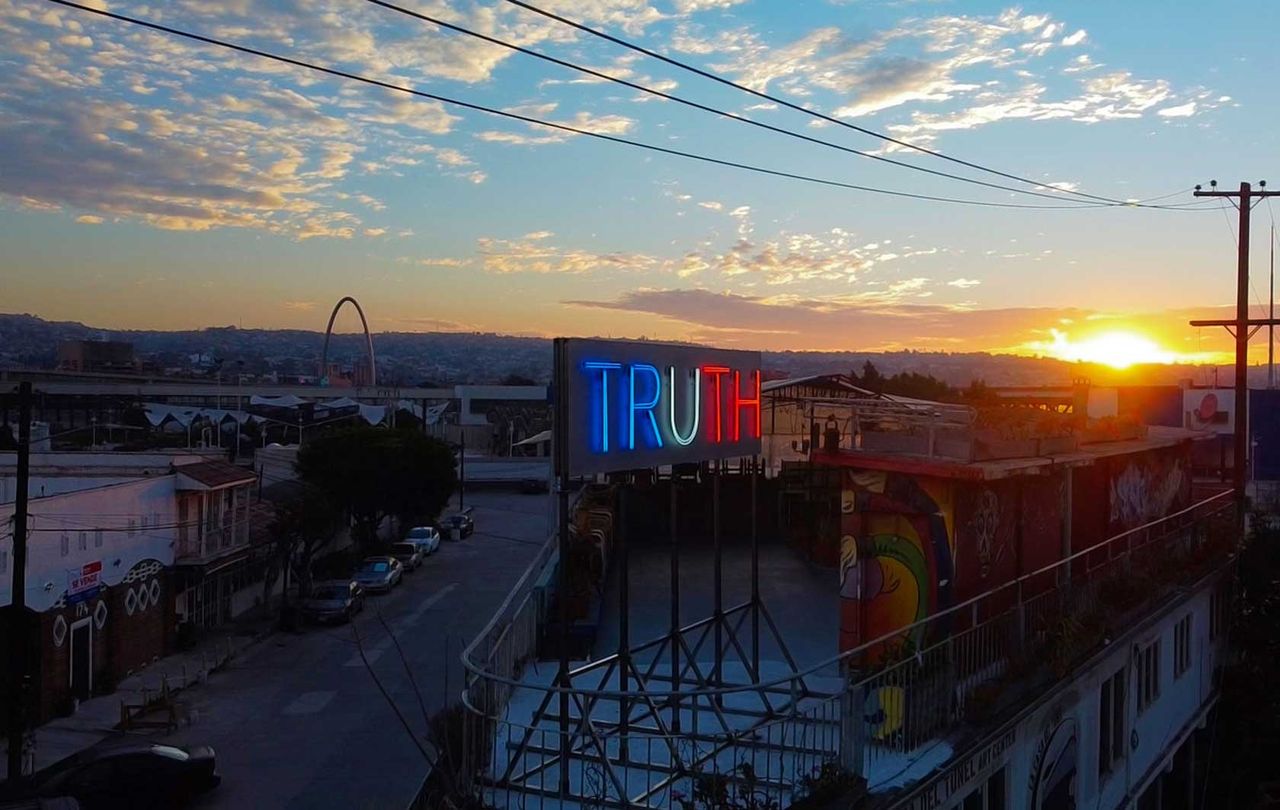 Stefan Brüggemann’s double-sided neon installation ’Truth / Lie’, installed on the roof of The Tunnel House in Tijuana, Mexico, overlooking the US/Mexico border