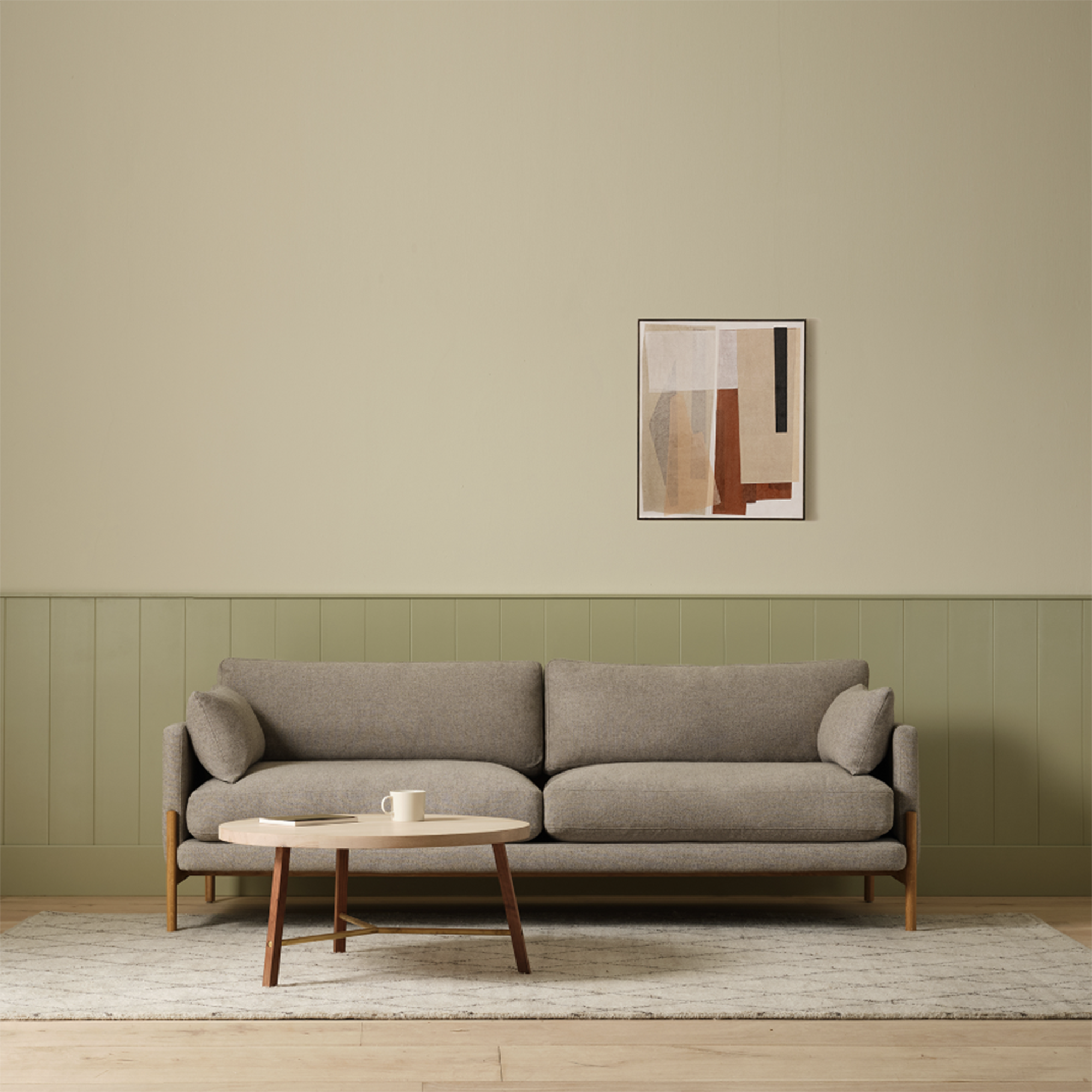 grey sofa in a minimalist green living room