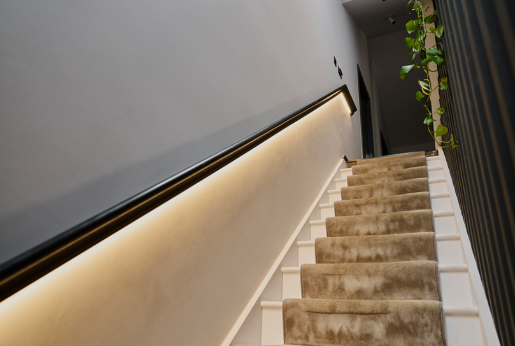 A staircase with fur carpet and white painted steps
