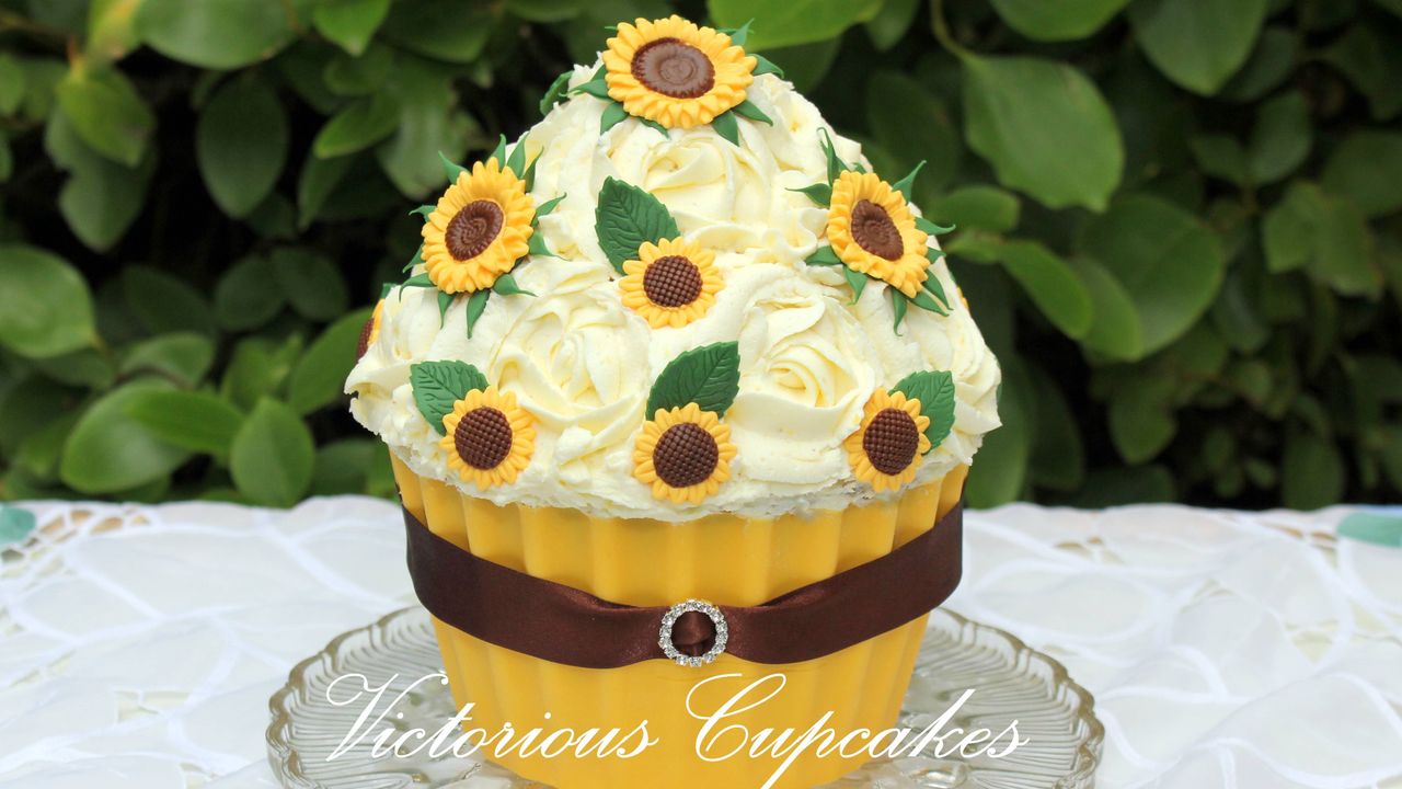 giant lemon cupcake on a glass serving plate