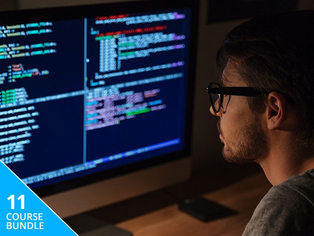 Man looking at a computer screen filled with code