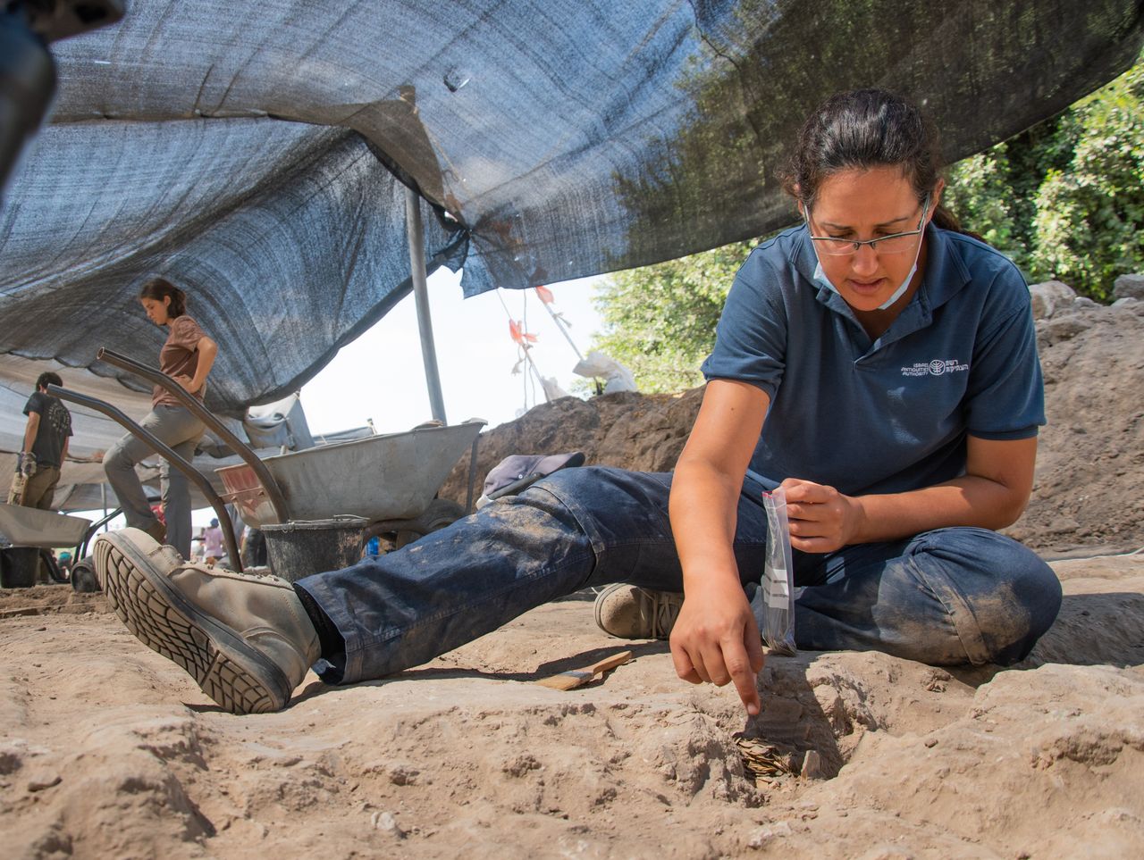 Liat Nadav-Ziv puts the pure gold coins in a plastic bag.