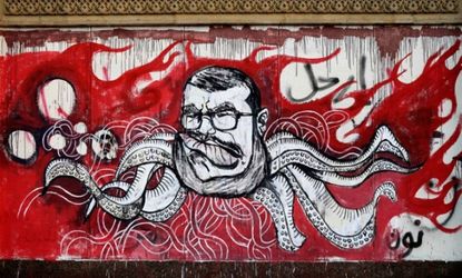 Graffiti depicting Mohamed Morsi covers an outer wall of the presidential palace in Cairo, Egypt.