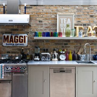 kitchen area with brick wall and worktop