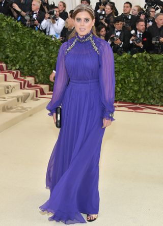 Princess Beatrice wearing a long purple dress with silver embellishments at the Met Gala 2018