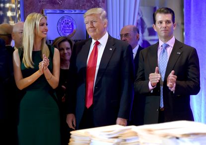 Donald Trump stands with children Ivanka and Donald Jr. 