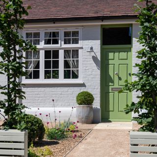 Front garden with gravel path and green door