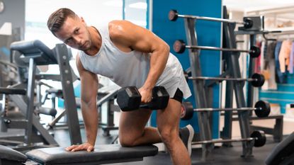 Man doing a dumbbell workout at the gym