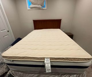 Saatva Organic Quilted Mattress Topper on a bed.