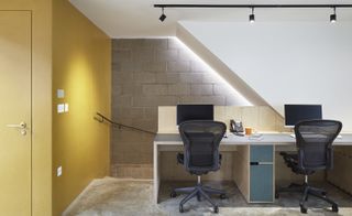 The commercial workspaces with concrete floors and raw plywood stairs