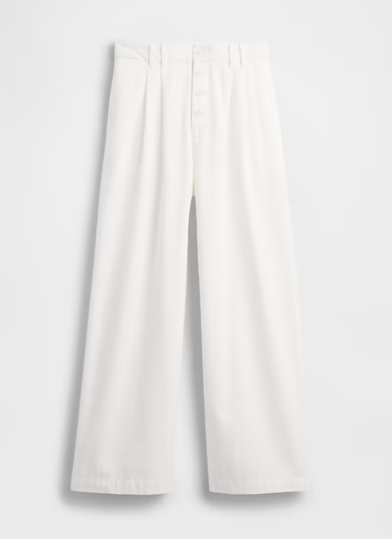 a pair of white gap trousers in front of a plain backdrop