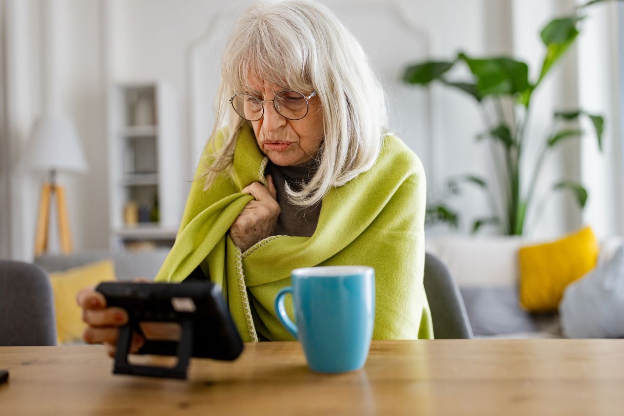 Elderly woman feeling cold at home