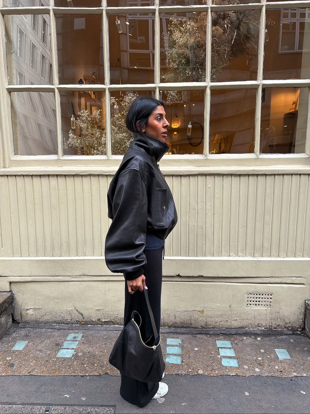 Influencer Monikh wearing a leather funnel neck jacket.