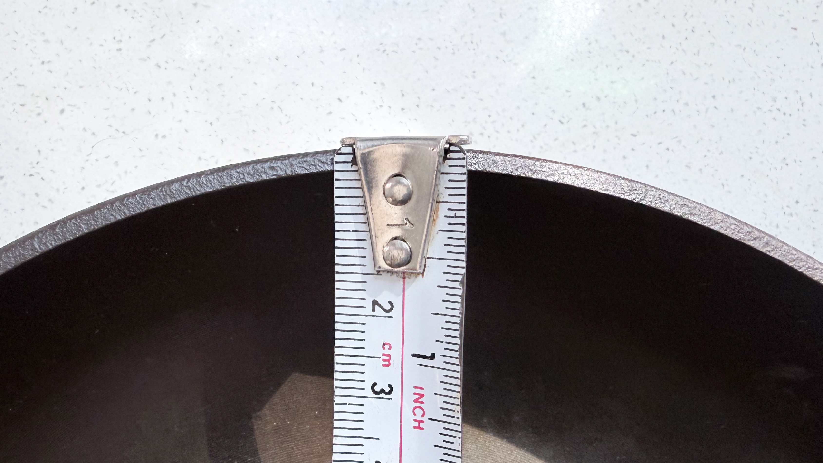 The Field Company Skillet being measured with a tape measure