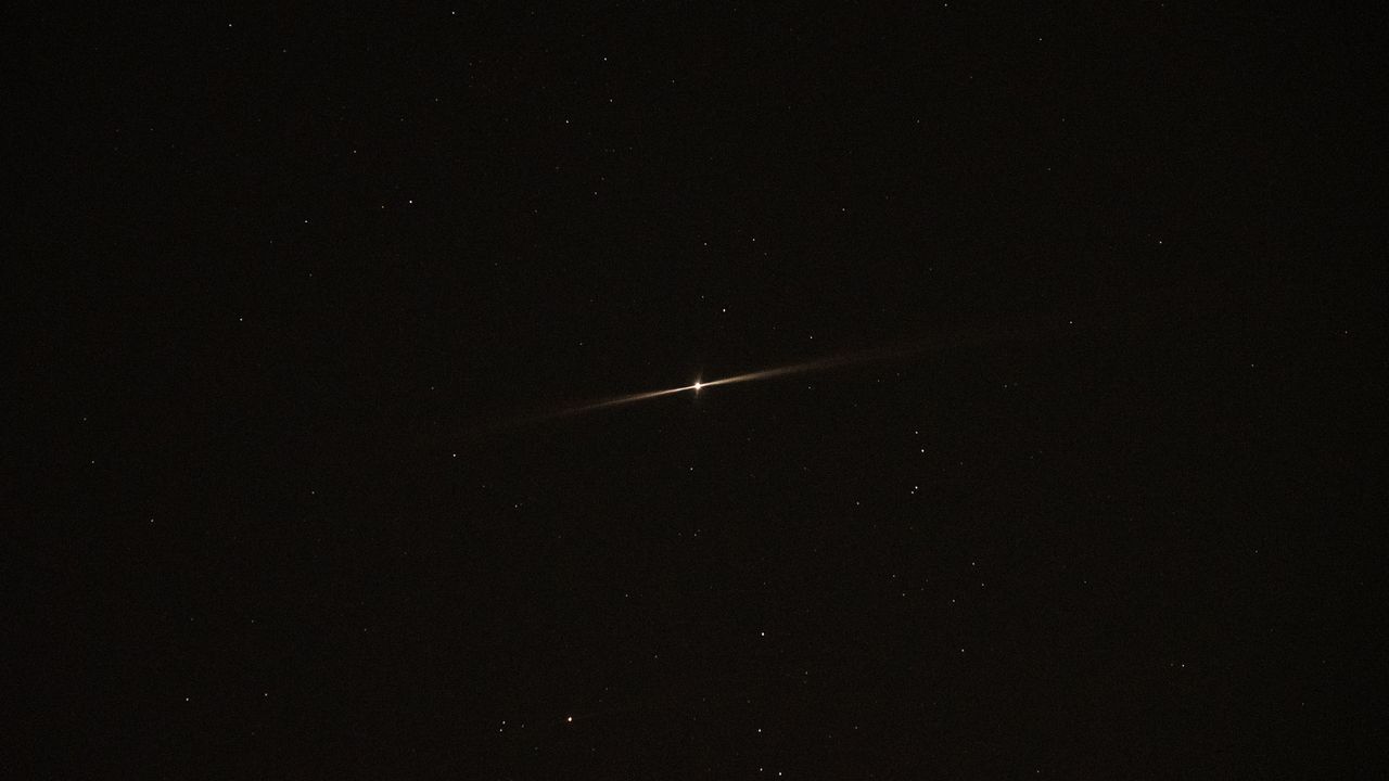 Jupiter shining with two beams in the night sky