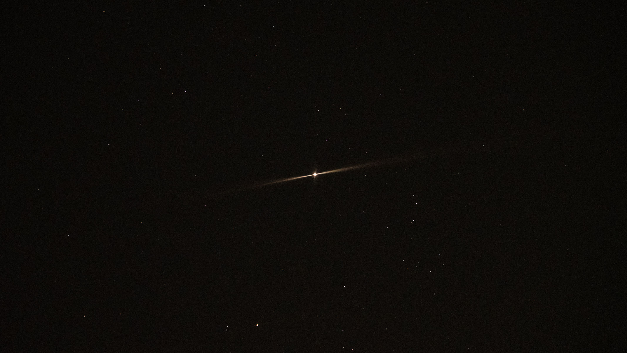 Jupiter shining with two beams in the night sky