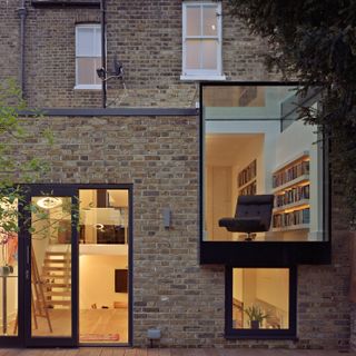 an extended and remodelled ground floor flat transformed into a modern two storey extension – with floor to ceiling glass windows and a sightline into the home with wooden floors