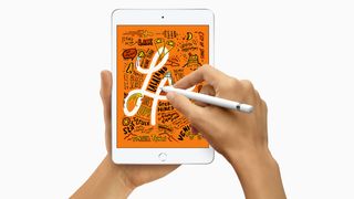 Apple iPad mini (2019, 5th generation) product shot with person using the Apple Pencil