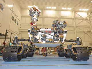 The Mars Science Laboratory rover, Curiosity, stands inside the Spacecraft Assembly Facility at NASA's Jet Propulsion Laboratory, Pasadena, Calif. The photograph was taken during mobility testing on June 3, 2011. Workers continue preparing to ship the rov