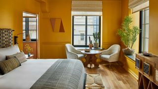 a yellow bedroom in a hotel