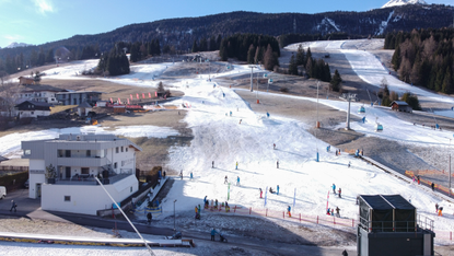 Skiers descend a slope of artificial snow below Grubigstein mountain on January 16, 2023 near Ehrwald, Austria