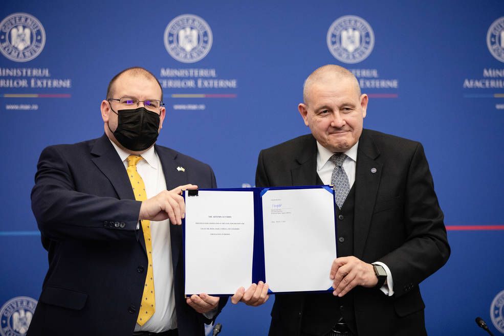 Romanian Space Agency President and CEO Marius-Ioan Piso (right) and U.S. Chargé d&#039;affaires to Romania David Muniz pose for a photo after Romania signed the Artemis Accords on March 1, 2022, the 16th country to do so. 