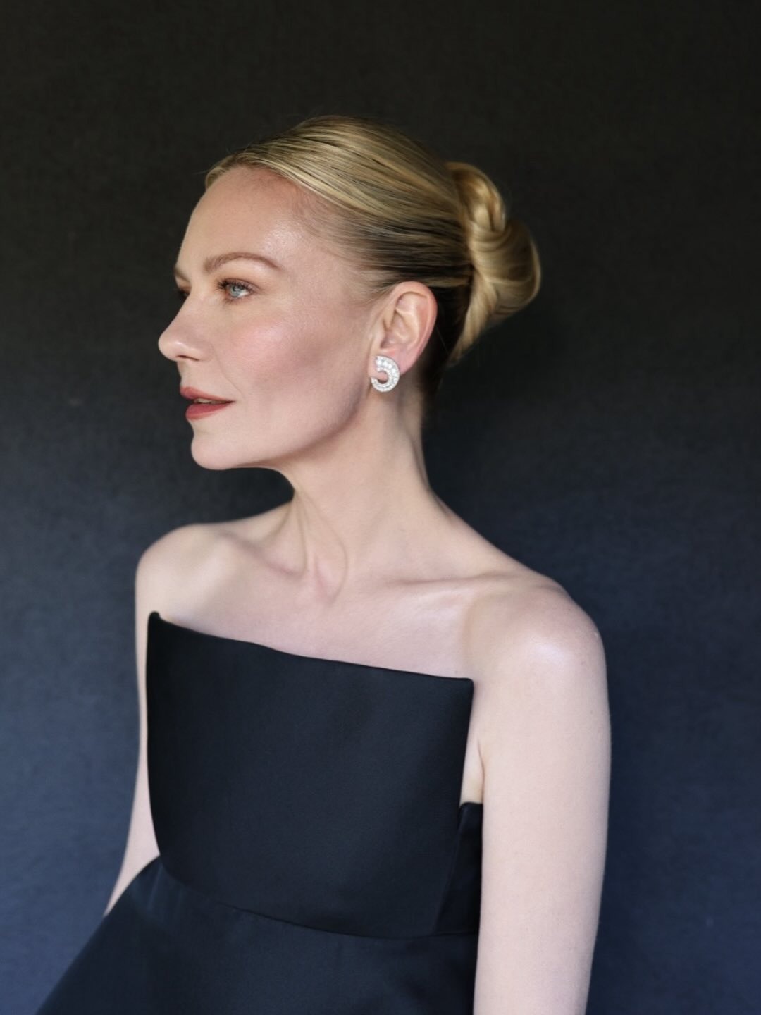 Kirsten Dunst with a glossy bun hairstyle