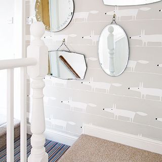 landing with white wall and mirrors on wall