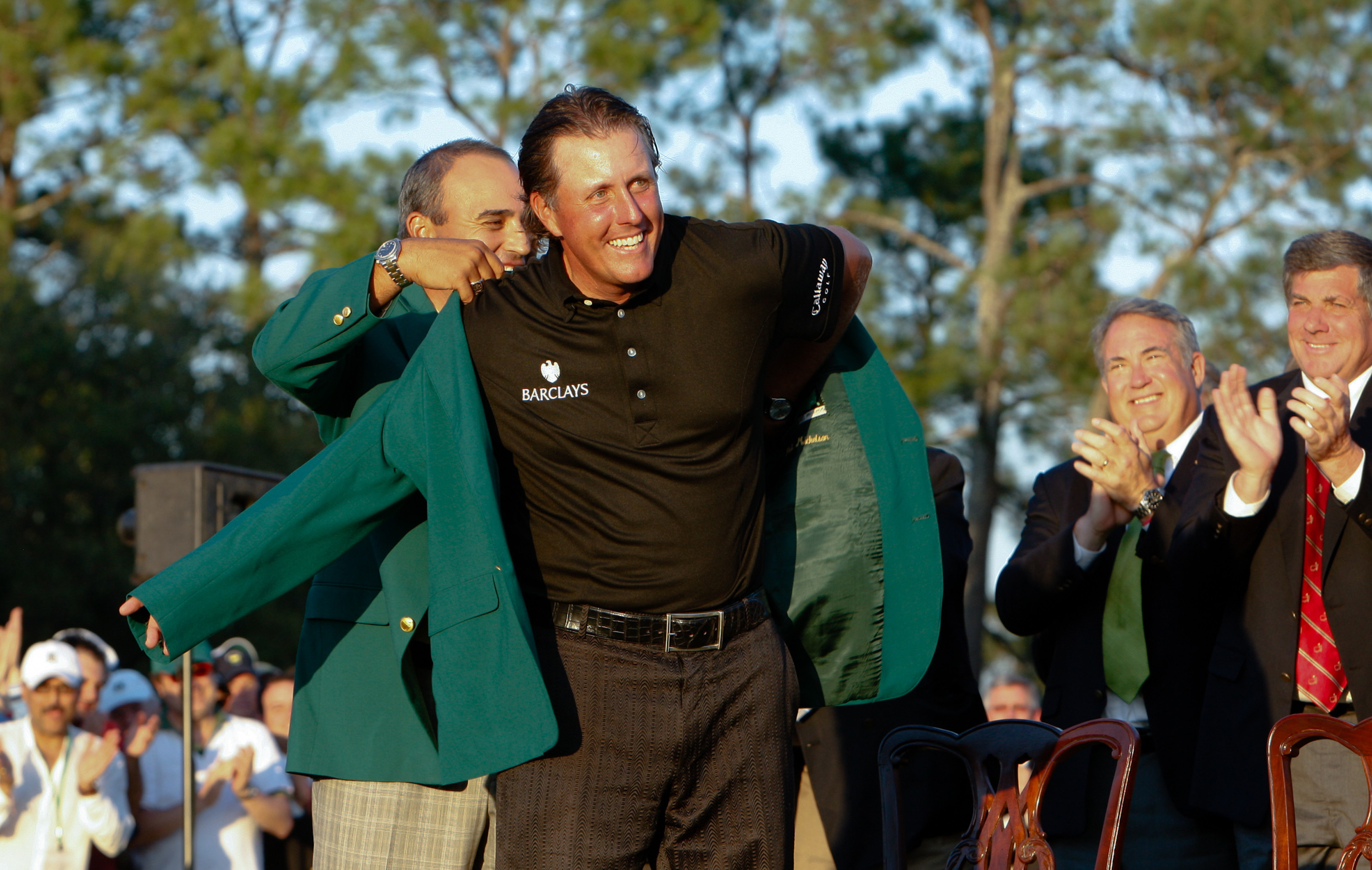Phil Mickelson receives his green jacket after his win at the Masters at Augusta National Golf Club in Augusta, Georgia