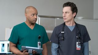 Zach Braff and Donald Faison looking at each other in the Scrubs revival