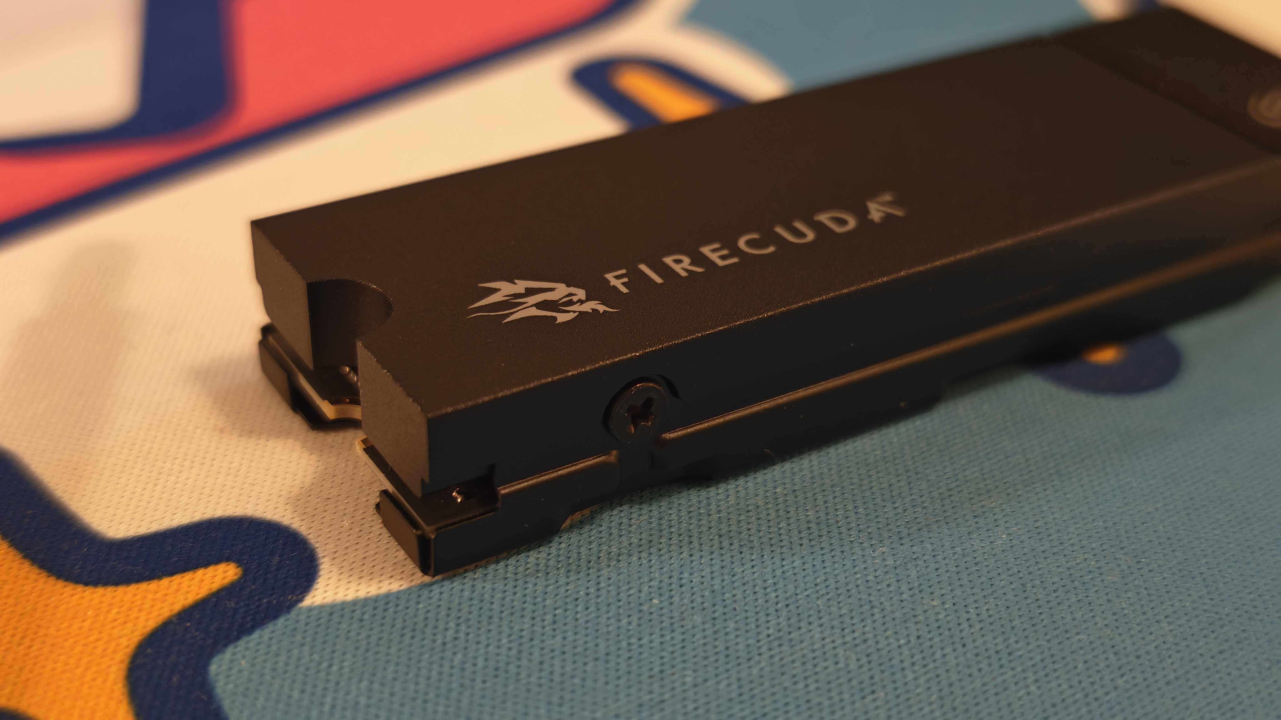 The Seagate FireCuda 530R with heatsink on a colorful fabric desk mat.