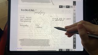 Adonit Neo Pro stylus being used to write on an iPad tablet