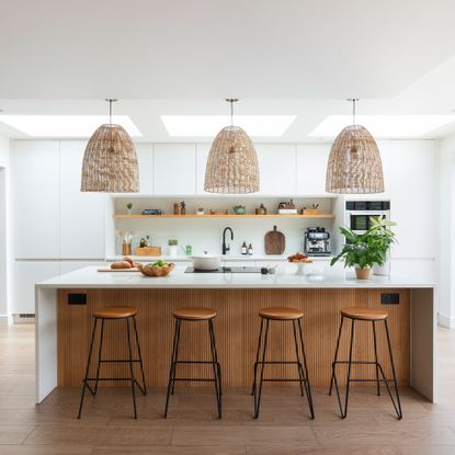 White kitchen with white worktops and kitchen islands