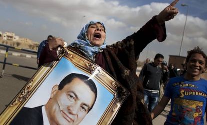 Supporters of Hosni Mubarak chant slogans and carry his portrait during his trial in February 2012.