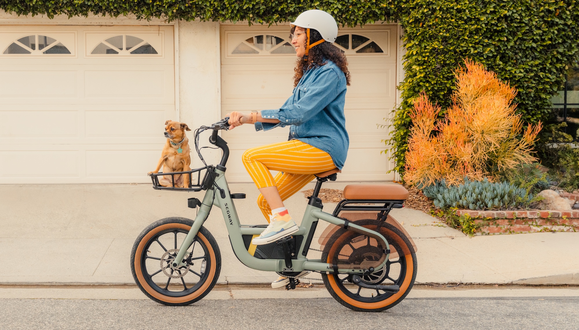 Woman riding Segway Muxi eBike with dog