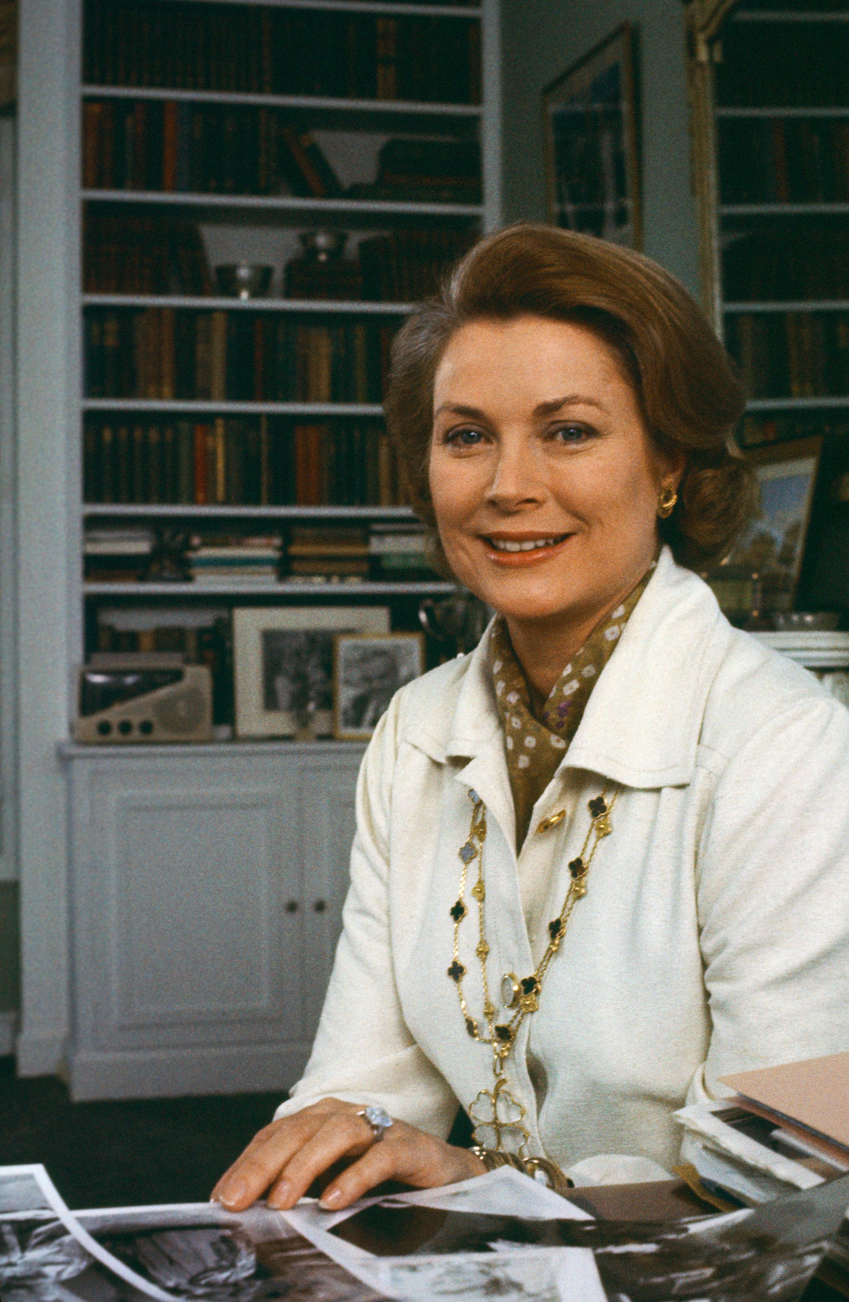 Grace Kelly sitting at a desk in her office