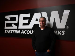 Headshot of Mark Posgay in front of the EAW sign.