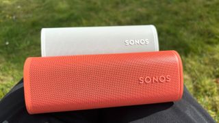 Sonos Roam in white behind Sonos Roam 2 in orange red