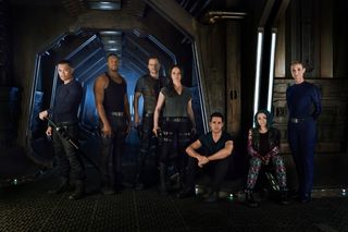 From L to R - Alex Mallari Jr. as Four, Roger Cross as Six, Anthony Lemke as Three, Melissa O'Neil as Two, Marc Bendavid as One, Jodelle Ferland as Five, Zoie Palmer as The Android