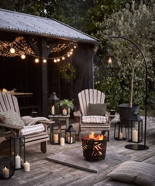 Evening Garden Setting in Summer with Lights Seating and Fire Bucket