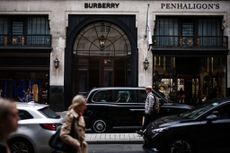 Pedestrians walk past the store of British fashion label Burberry, in central London