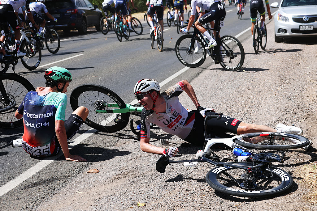 WILLUNGA, AUSTRALIA - JANUARY 24: (L-R) Antoine L'Hote of France and Decathlon CMA CGM Team and Vegard Stake Laengen of Norway and UAE Team Emirates crash during the 26th Santos Tour Down Under 2026, Stage 4 a 130.8km stage from Brighton to Willunga / #UCIWT / on January 24, 2026 in Willunga, Australia. (Photo by Con Chronis/Getty Images)