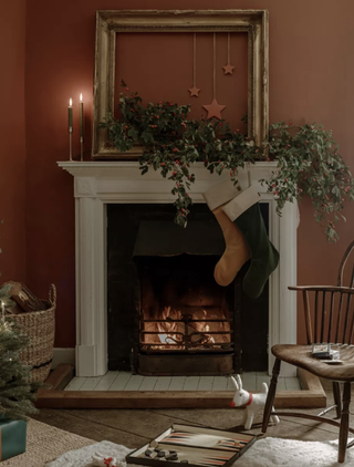 stockings hanging from a mantelpiece in an orange living room