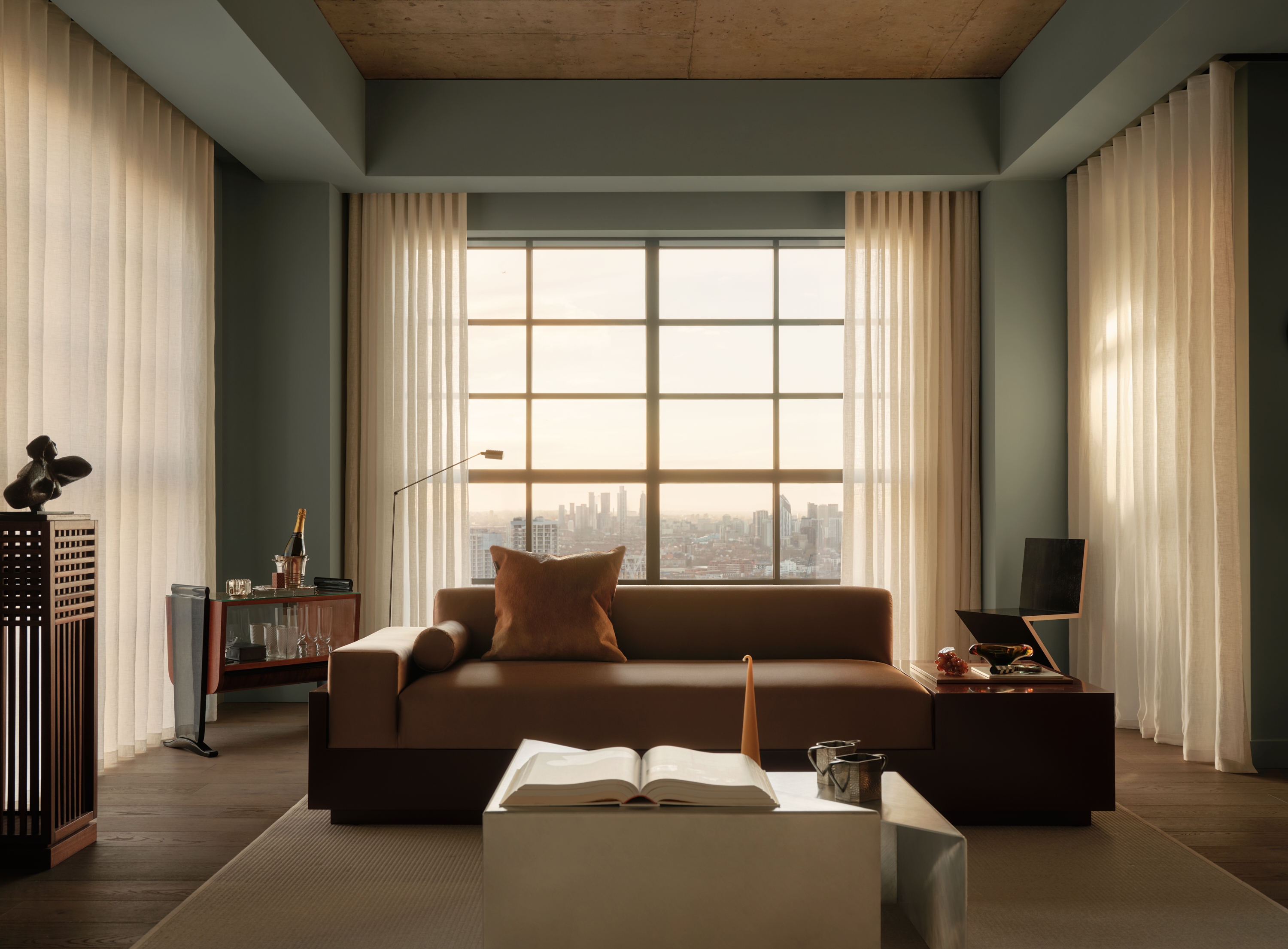 view of the Penthouse at The Founding by Conran and Partners, including timber based furniture and warm colours under moody lighting