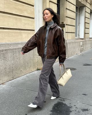 french woman wearing brown leather jacket outfit