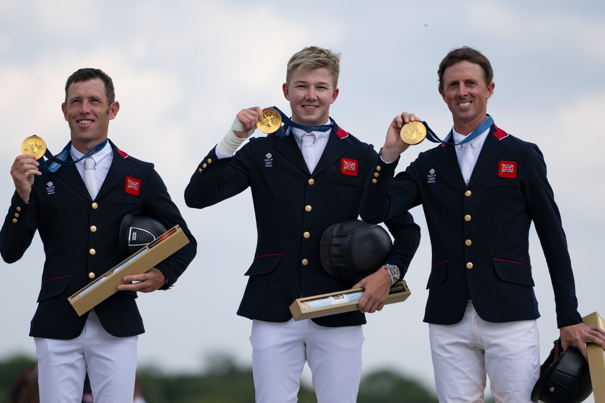 Scott Brash, Harry Charles and Ben Maher of Team Great Britain celebrate winning gold medal during the Jumping Team Final on day seven of the Olympic Games Paris