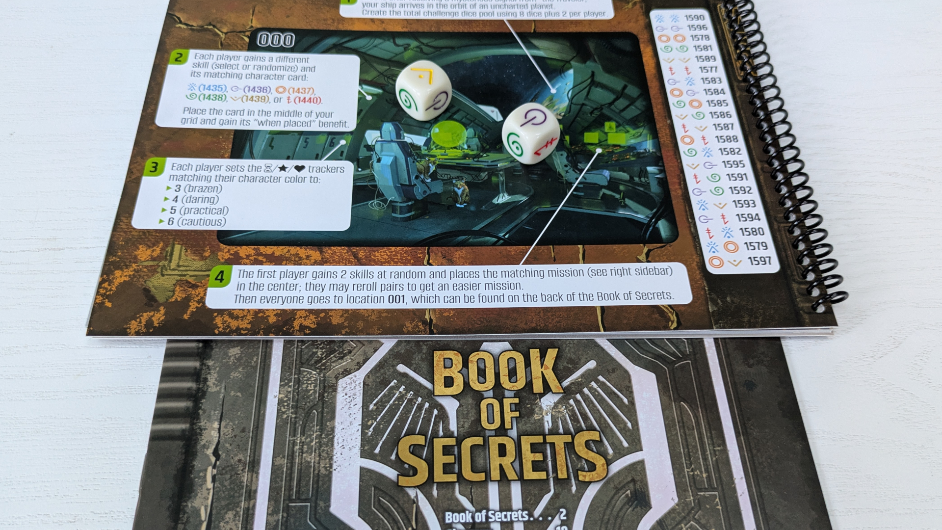 Vantage booklets with tokens and cards sat atop them, all on a wooden surface