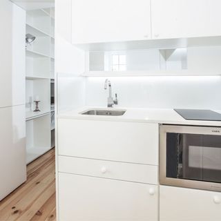 kitchen with white wall and skink
