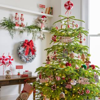 A Christmas tree decorated with sweets and candy-themed decorations