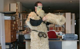 Man putting on a furry costume